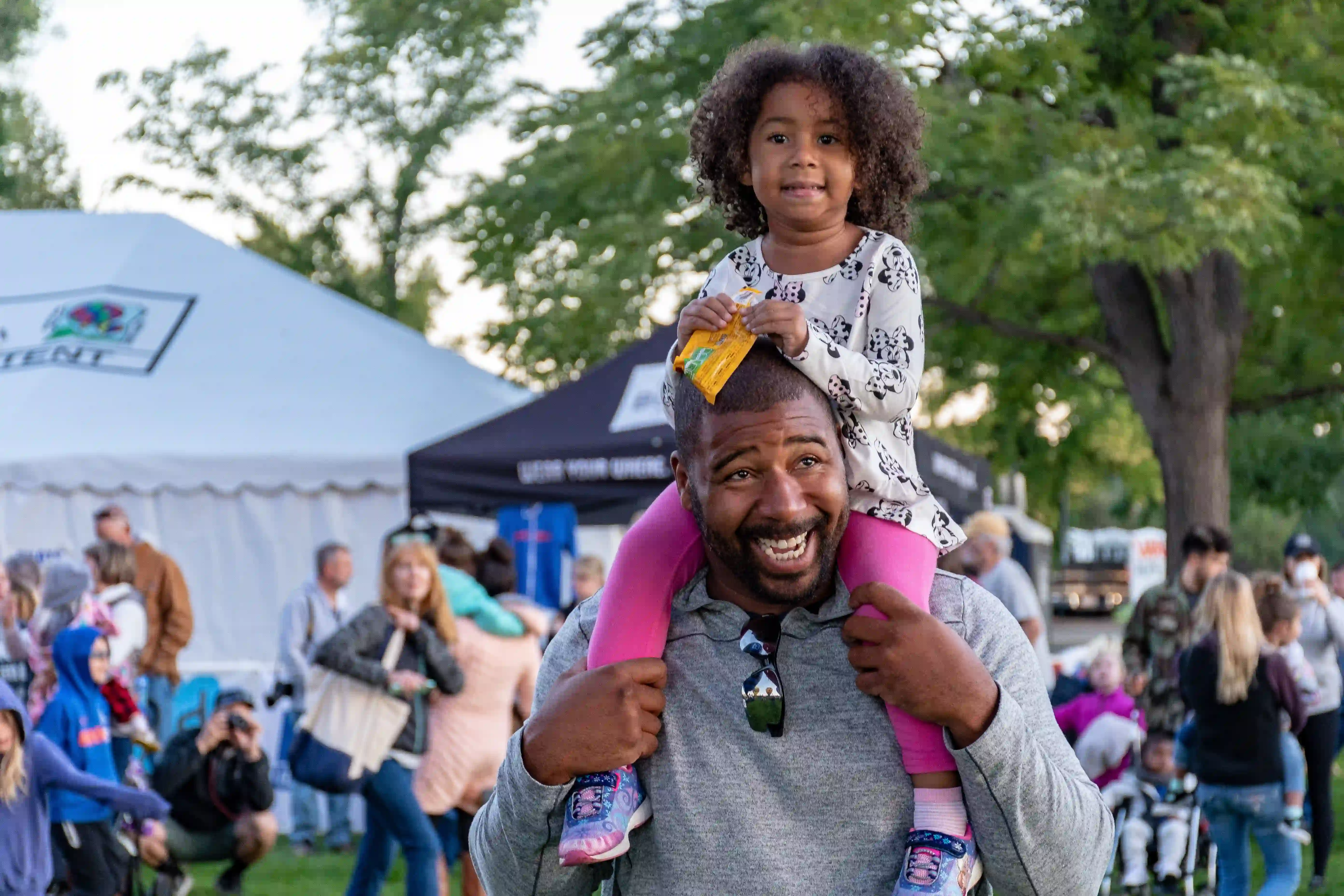 child on dad's shoulder